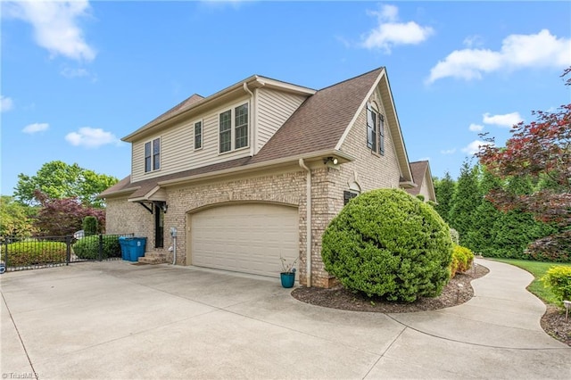 3303 Tanner Ct, Summerfield, NC 27358 - view of side of home featuring brick siding, driveway, fence, and a garage