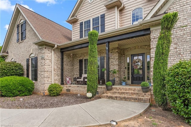 3303 Tanner Ct, Summerfield, NC 27358 - property entrance featuring a shingled roof, brick siding, and covered porch
