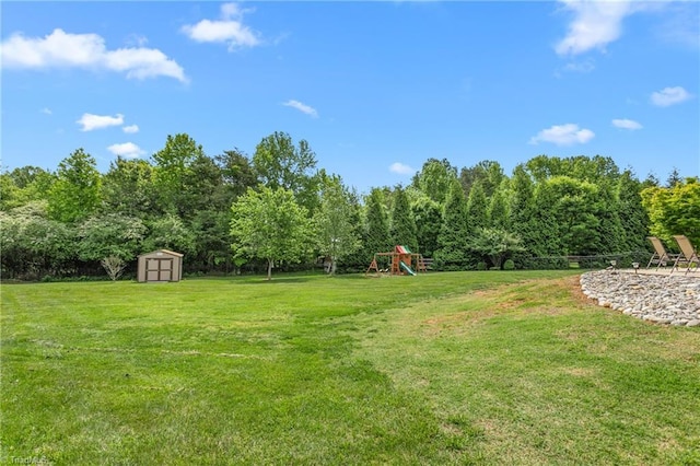 3303 Tanner Ct, Summerfield, NC 27358 - view of yard with a storage unit, an outdoor structure, and a playground