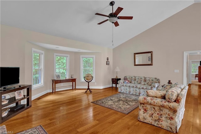 living room featuring ceiling fan, plenty of natural light, and light hardwood / wood-style flooring