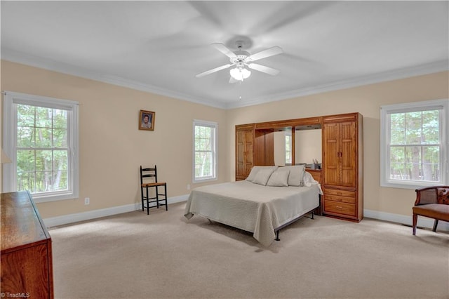 carpeted bedroom with ceiling fan and ornamental molding