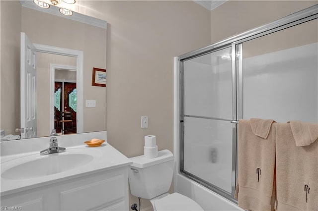 full bathroom with combined bath / shower with glass door, vanity, and toilet