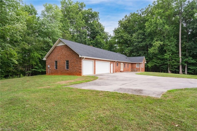 view of side of property featuring a garage and a yard