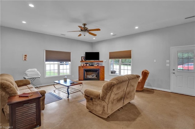 living room with a wealth of natural light and ceiling fan