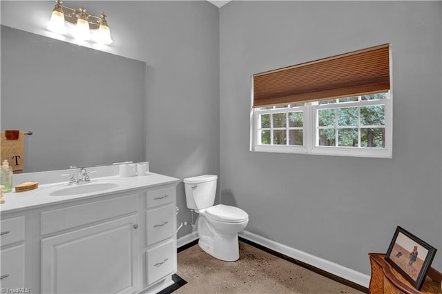 bathroom featuring toilet and vanity