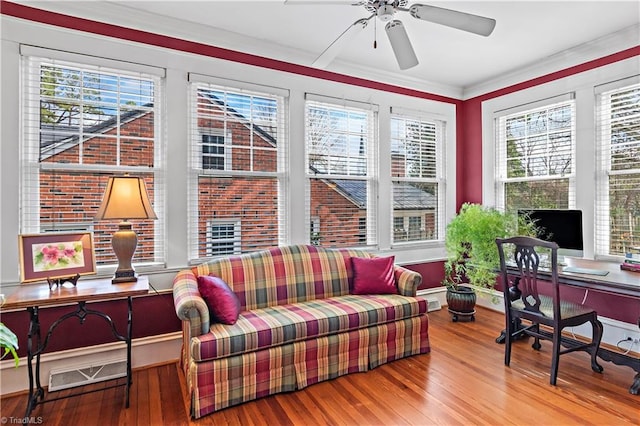 office with a ceiling fan, wood finished floors, visible vents, and ornamental molding