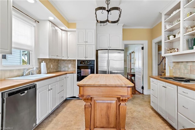 kitchen with white cabinets, stainless steel appliances, wood counters, and ornamental molding