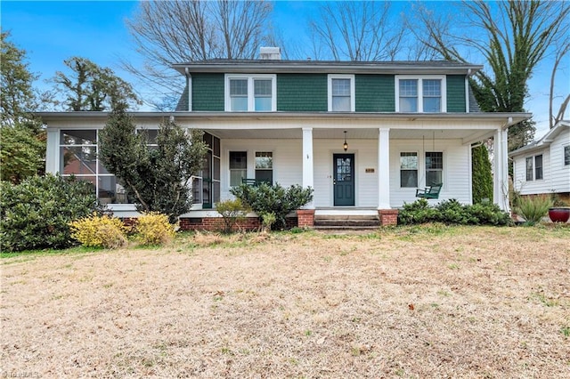 view of front of property featuring a porch and a chimney