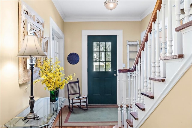 entrance foyer featuring stairway and ornamental molding