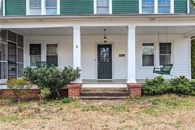 entrance to property featuring a porch