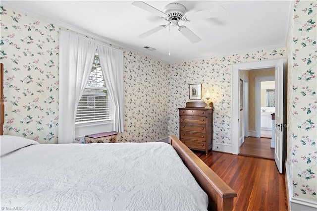 bedroom featuring visible vents, wallpapered walls, baseboards, wood finished floors, and a ceiling fan