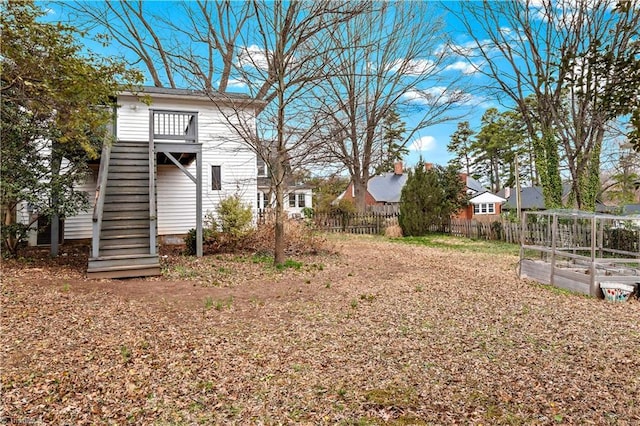 view of yard featuring stairway and fence