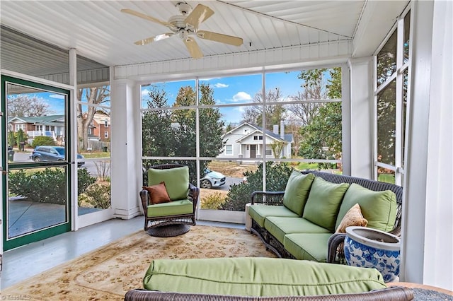 sunroom / solarium featuring a residential view and ceiling fan