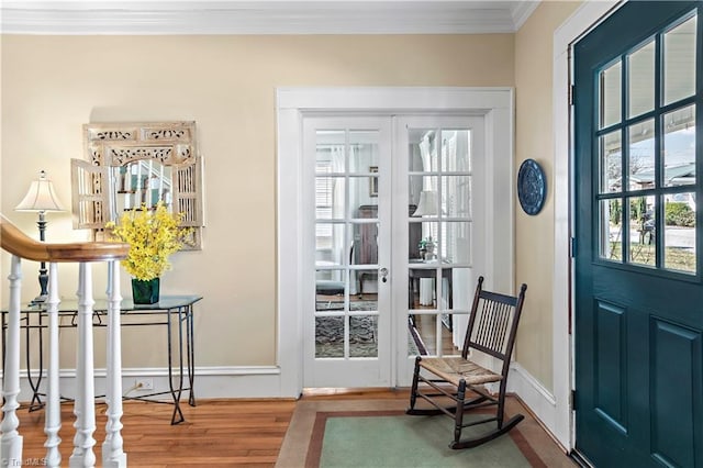 doorway featuring stairway, wood finished floors, baseboards, french doors, and crown molding