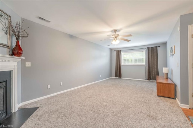 6919 Channel Forest Rd, Belews Creek, NC 27009 - unfurnished living room with a ceiling fan, a glass covered fireplace, and light carpet