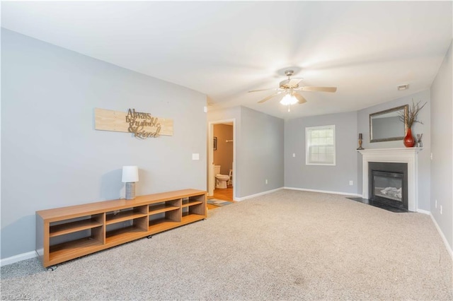 6919 Channel Forest Rd, Belews Creek, NC 27009 - unfurnished living room with carpet floors, ceiling fan, and a fireplace with flush hearth