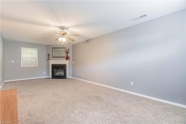 6919 Channel Forest Rd, Belews Creek, NC 27009 - unfurnished living room with a ceiling fan, carpet, and a fireplace with flush hearth