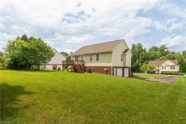 6919 Channel Forest Rd, Belews Creek, NC 27009 - rear view of house featuring stairway, a garage, a wooden deck, brick siding, and a lawn