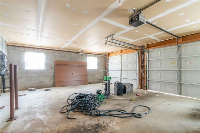 6919 Channel Forest Rd, Belews Creek, NC 27009 - garage featuring a garage door opener and concrete block wall
