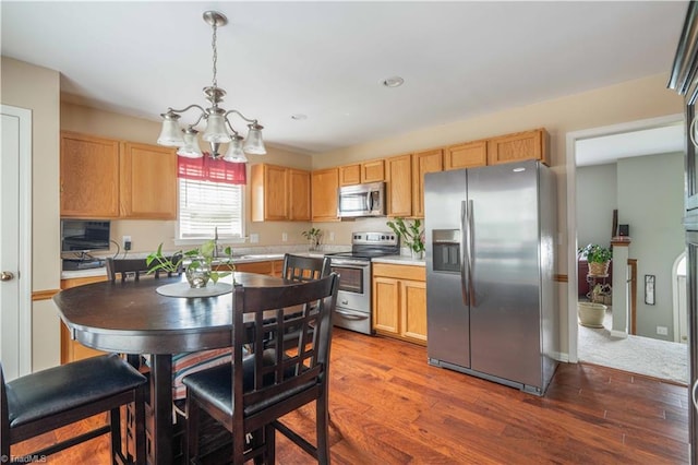6919 Channel Forest Rd, Belews Creek, NC 27009 - kitchen with appliances with stainless steel finishes, a chandelier, light countertops, dark wood-style floors, and recessed lighting