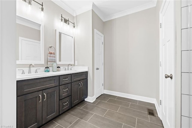 bathroom featuring double vanity, visible vents, ornamental molding, and a sink