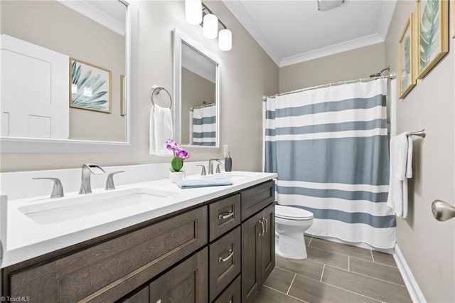 full bath featuring double vanity, toilet, ornamental molding, and a sink