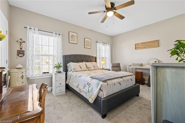 bedroom featuring ceiling fan, baseboards, and carpet