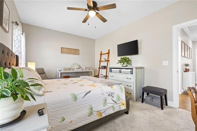 carpeted bedroom featuring baseboards and ceiling fan