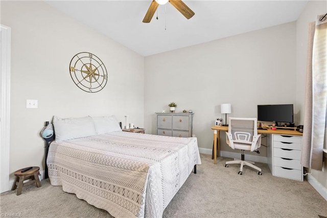 carpeted bedroom with a ceiling fan and baseboards
