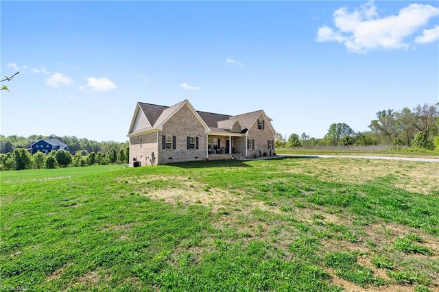 exterior space with brick siding and a yard