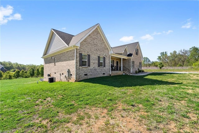view of home's exterior with central air condition unit, brick siding, a yard, and crawl space