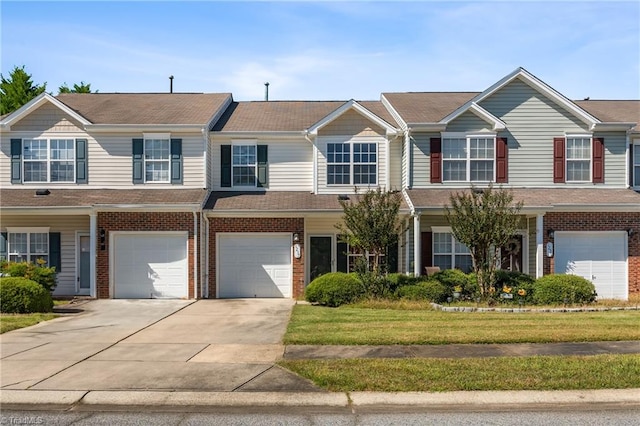 townhome / multi-family property with a front yard and a garage