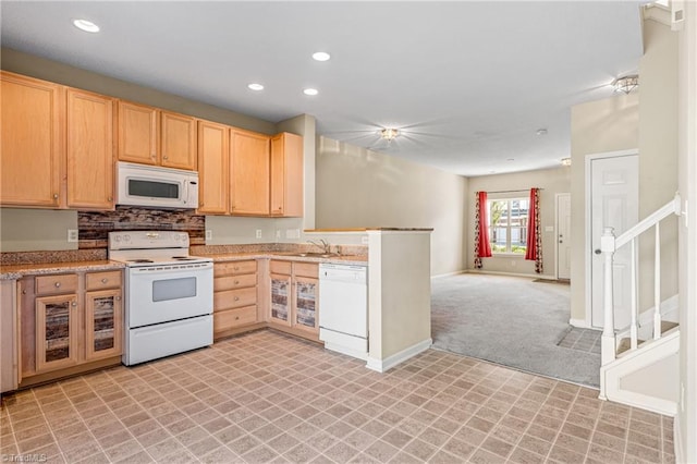 kitchen with light colored carpet, light brown cabinets, backsplash, and white appliances