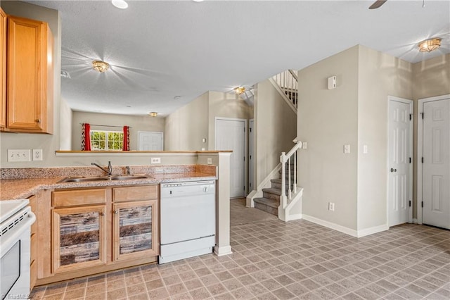 kitchen featuring kitchen peninsula, sink, and white appliances