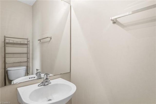 bathroom featuring sink and toilet