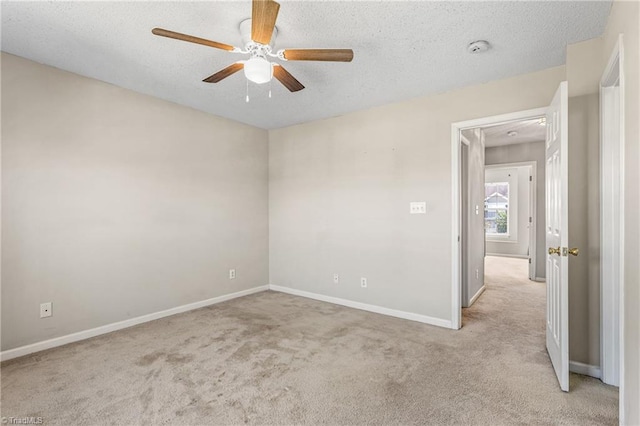 spare room with light carpet, a textured ceiling, and ceiling fan