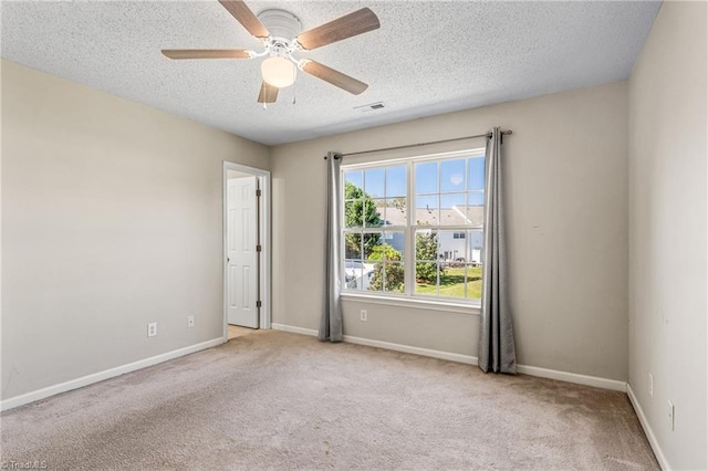 unfurnished room with light carpet, ceiling fan, and a textured ceiling