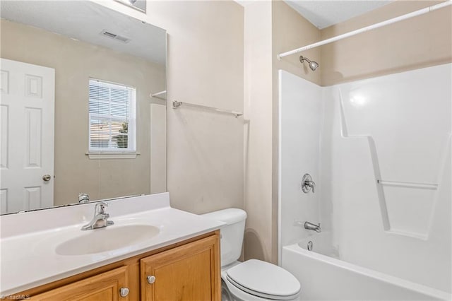 full bathroom featuring vanity, shower / bath combination, and toilet