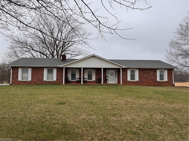 545 Angell Rd, Mocksville, NC 27028 - ranch-style home with brick siding, a front lawn, a porch, and a chimney