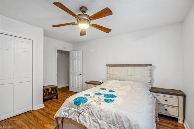 bedroom with ceiling fan, a closet, and hardwood / wood-style floors