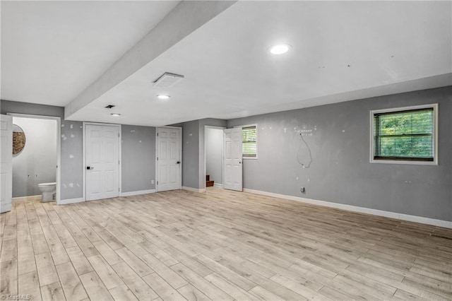 basement featuring light hardwood / wood-style floors and a healthy amount of sunlight