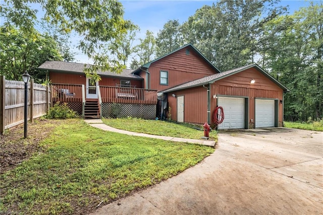 front of property featuring a deck, a front yard, and a garage