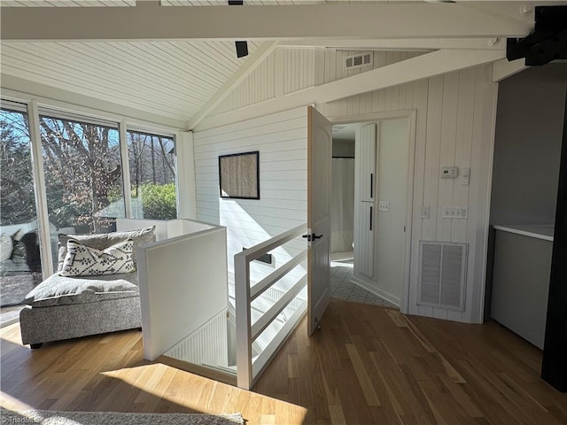 corridor featuring vaulted ceiling with beams, hardwood / wood-style flooring, and wooden walls