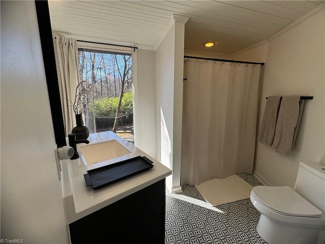 bathroom with toilet and wooden ceiling