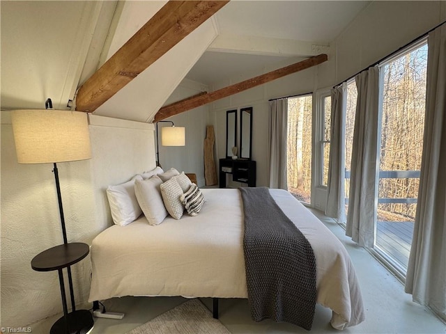 bedroom featuring vaulted ceiling with beams, access to exterior, multiple windows, and concrete flooring