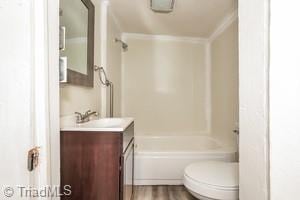 full bathroom with toilet, shower / bathing tub combination, vanity, and wood-type flooring