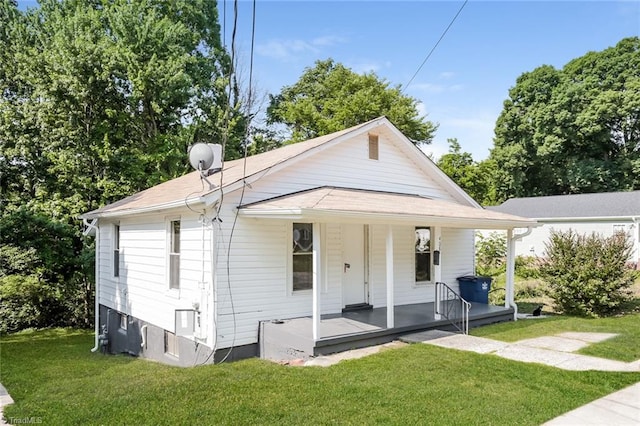 exterior space featuring a lawn and covered porch