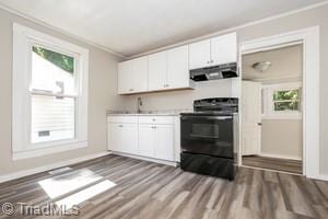 kitchen with white cabinets, light wood-type flooring, stove, and crown molding