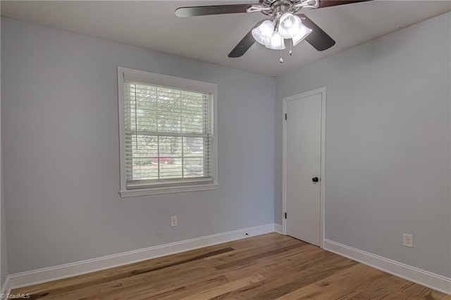 empty room with light wood-style flooring, ceiling fan, and baseboards