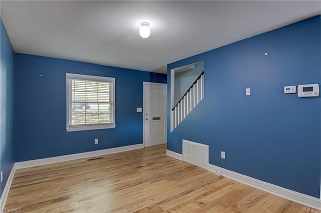 interior space with wood finished floors, visible vents, and stairs